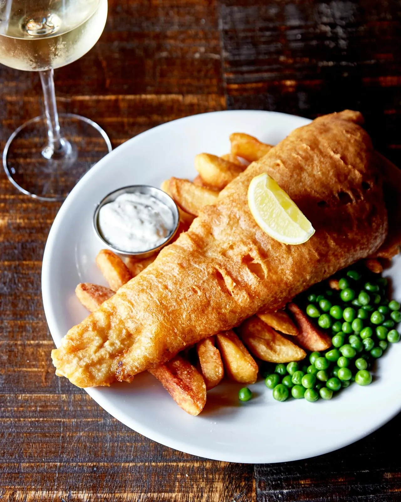 Hand battered fish and chips with peas and lemon at The Horns