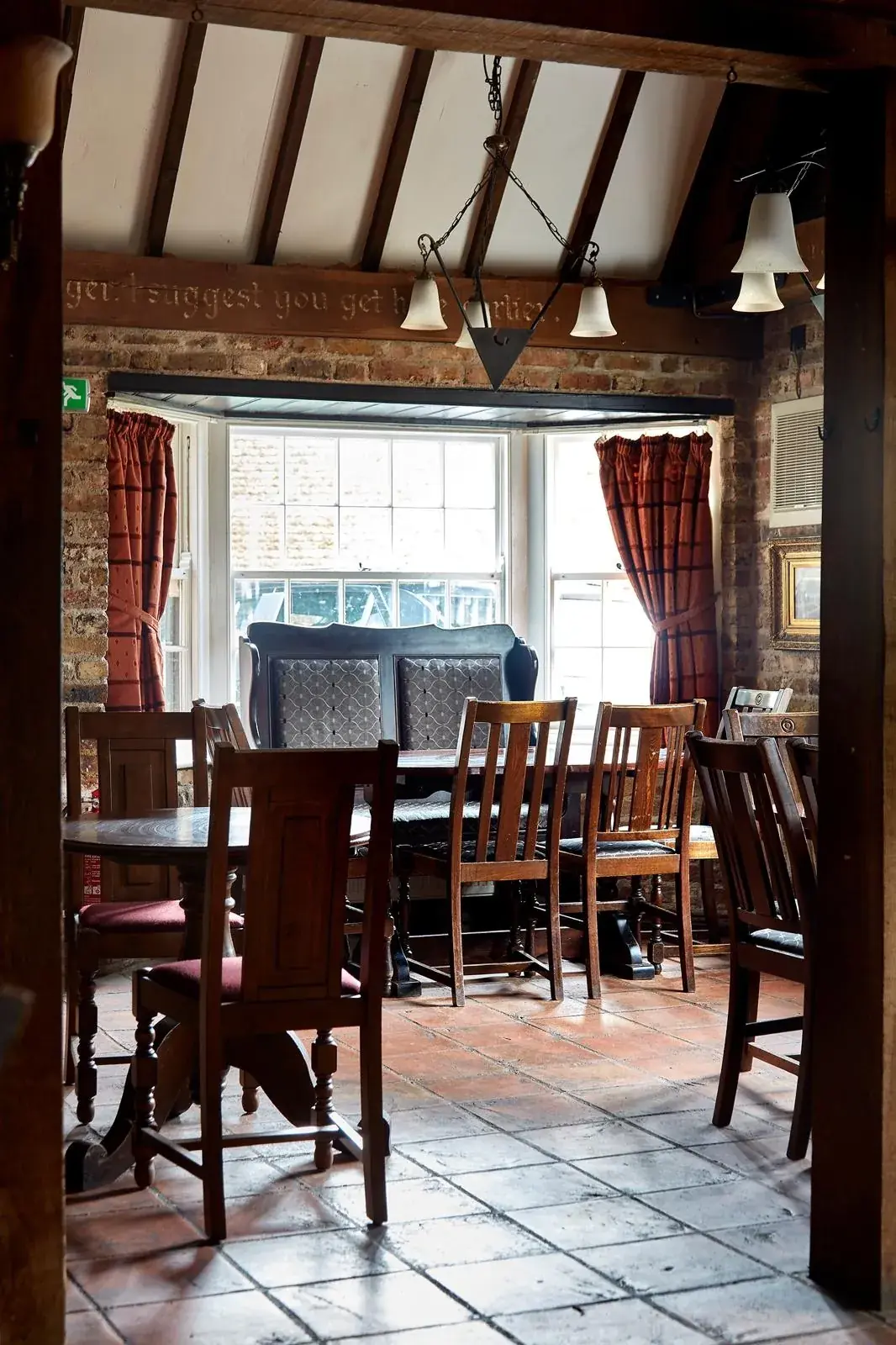 A table beside the window beneath the Tudor beams at The Horns