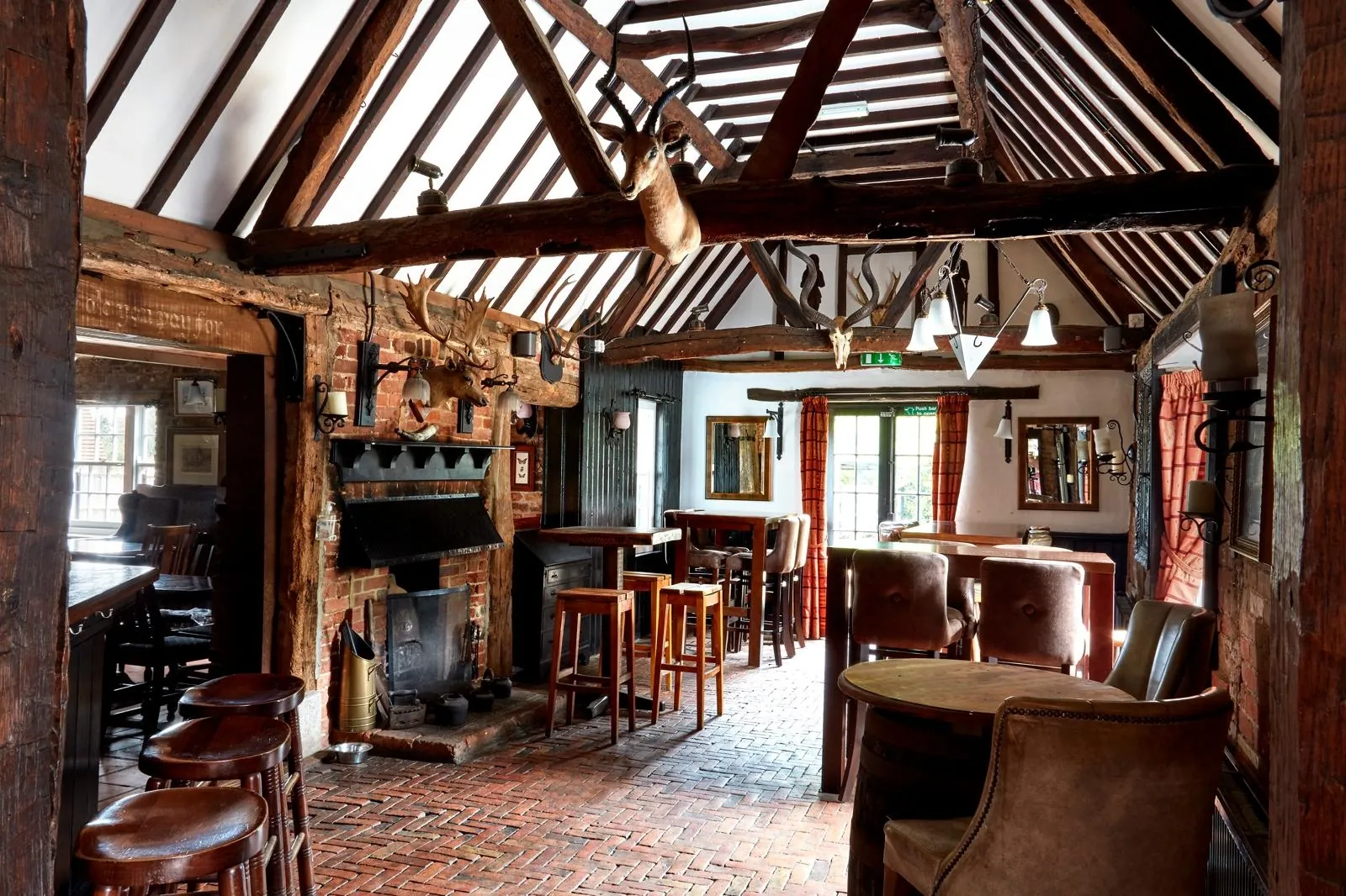 The bar room beneath original Tudor beams at The Horns